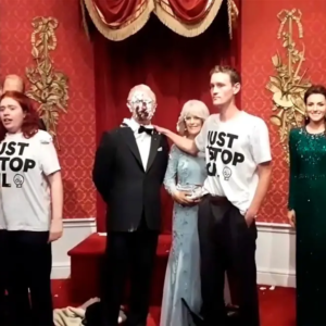 Activistas arrojan pasteles al rostro de la figura de cera de Carlos III